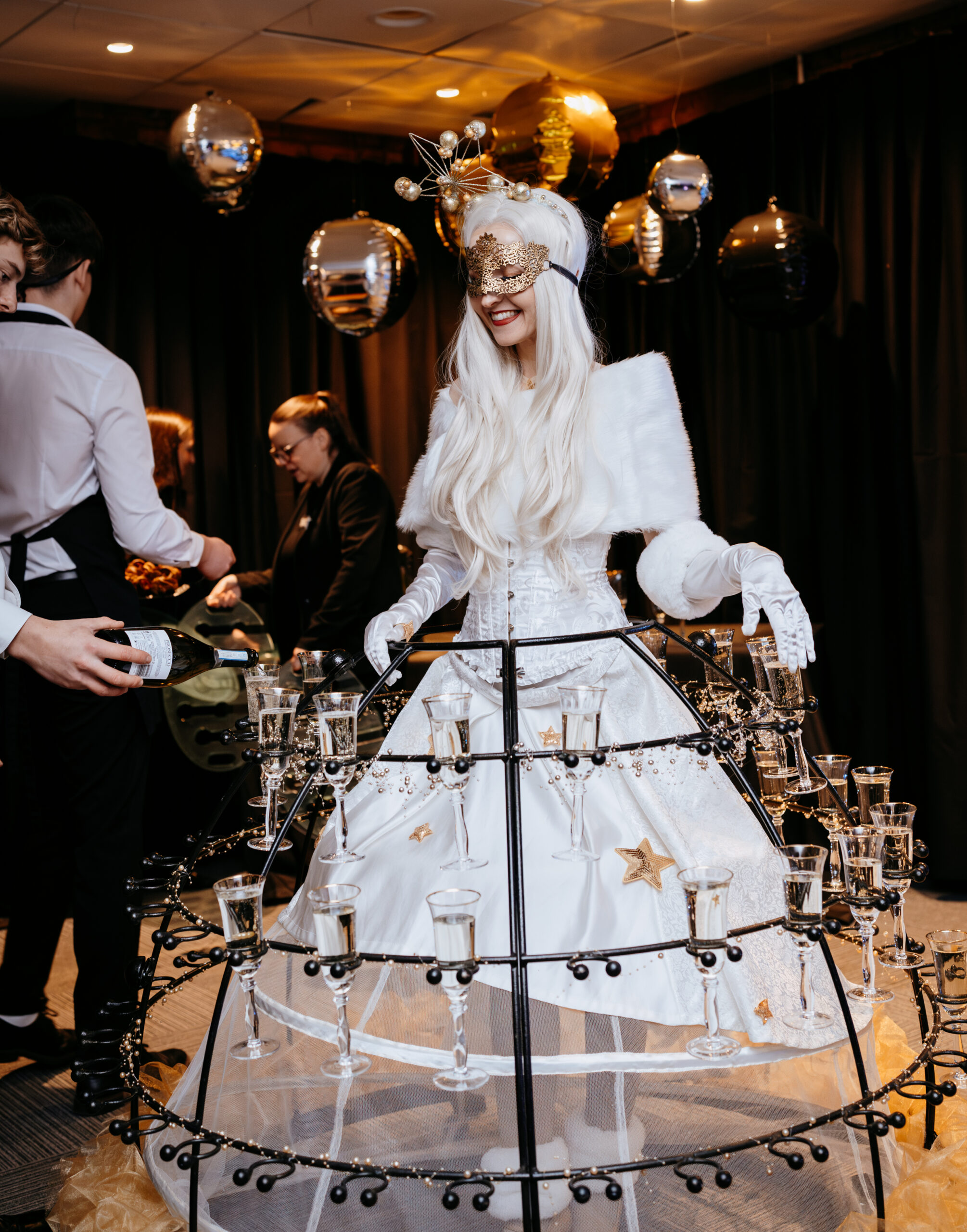 Nova Events Champagne Dress performer serving welcome drinks at a glamorous corporate party, adding sparkle and unforgettable entertainment